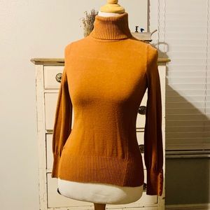 Burnt orange turtle neck with button accents